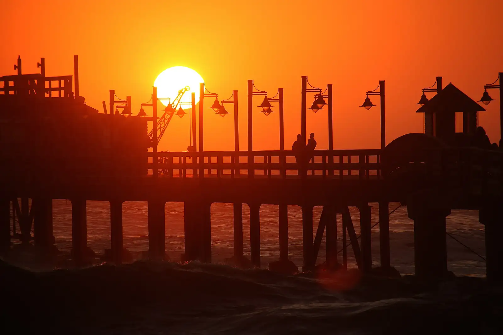 Swakopmund jetty silhouetted against the sunset over the Atlantic