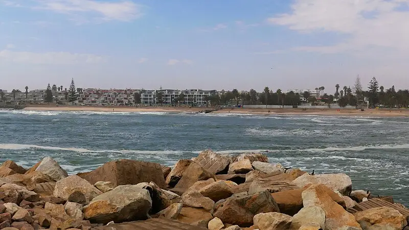Swakopmund skyline seen across the water from the rocks of the Mole