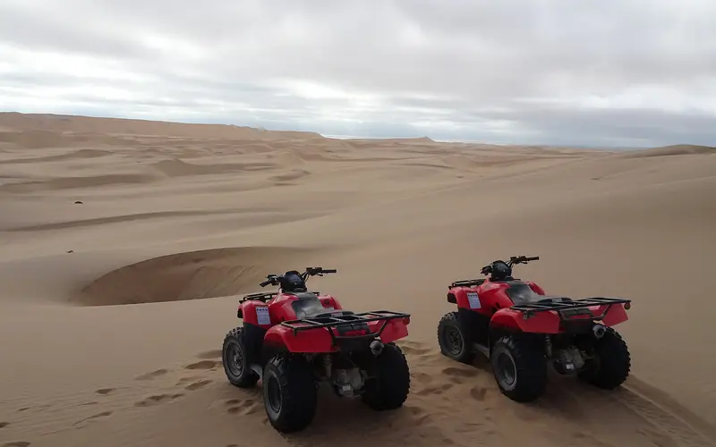 Two quad bikes parked on the dunes near Swakopmund