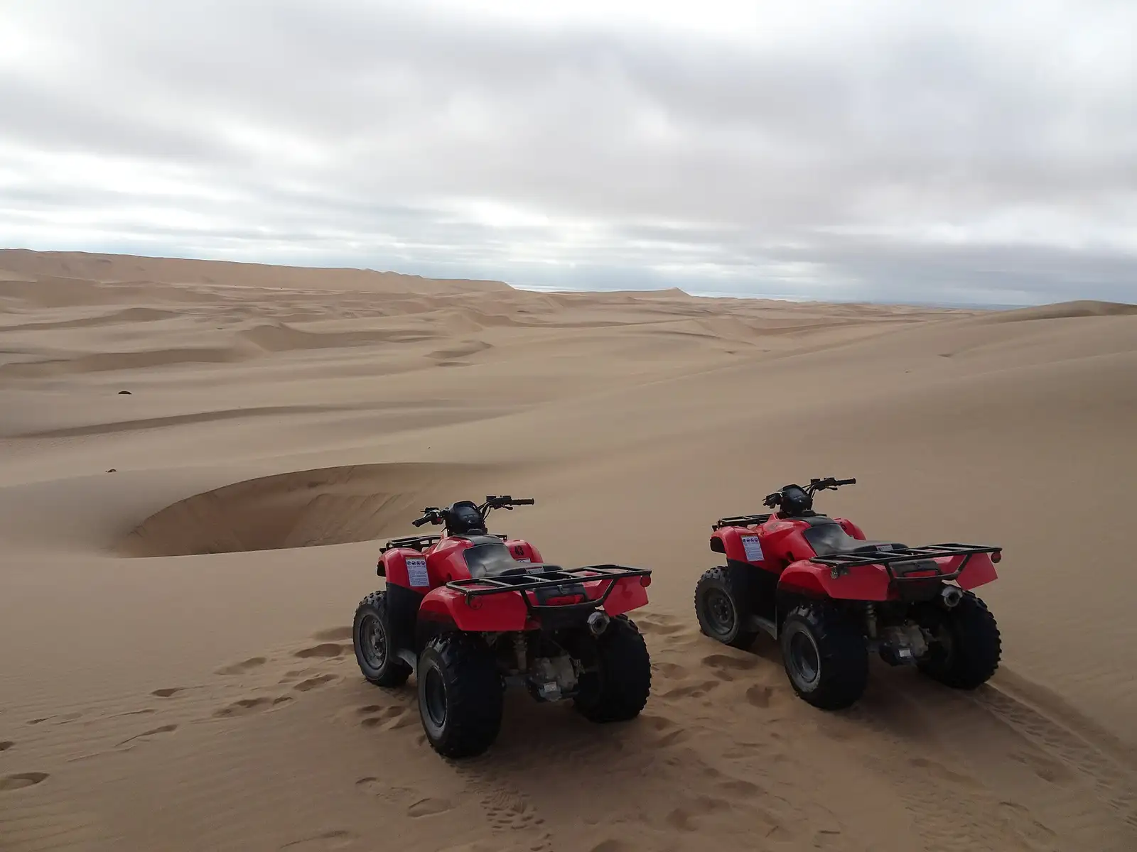 Two quad bikes parked on the dunes near Swakopmund